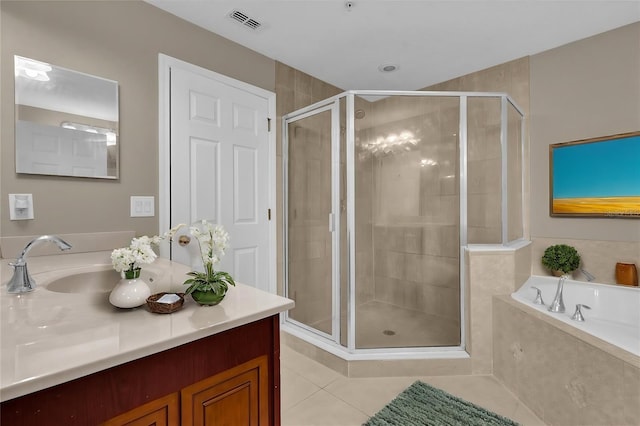 bathroom featuring tile patterned flooring, vanity, and shower with separate bathtub