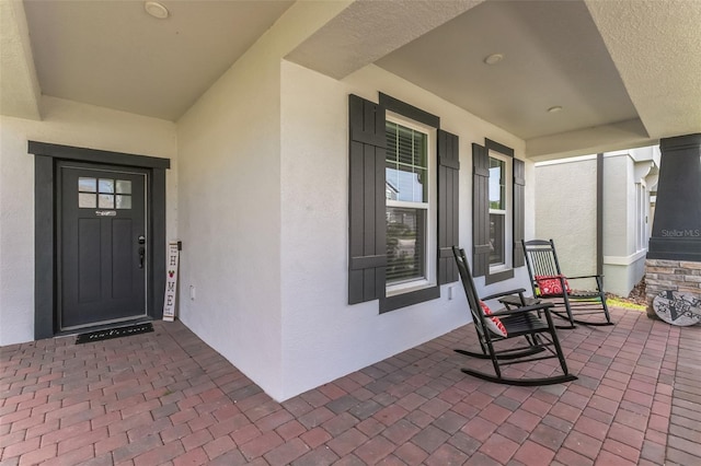 property entrance with covered porch