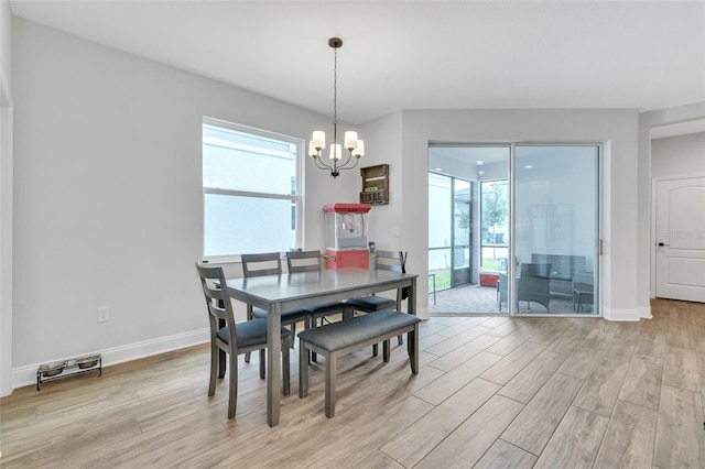 dining area featuring an inviting chandelier and light wood-type flooring