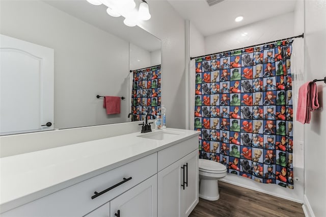 bathroom featuring vanity, hardwood / wood-style floors, and toilet