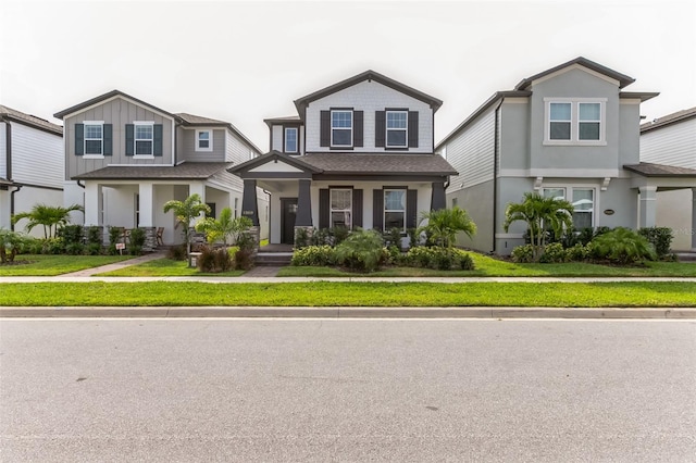 view of front of home with covered porch and a front yard