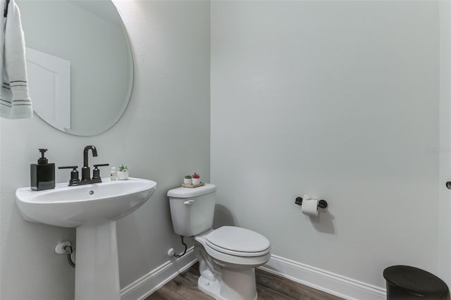 bathroom featuring hardwood / wood-style flooring and toilet