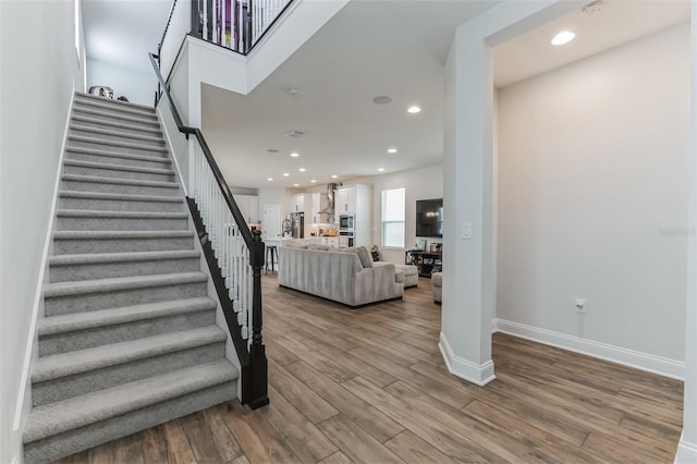 stairway with hardwood / wood-style floors