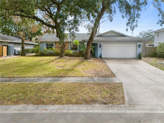 ranch-style home with a garage and a front lawn