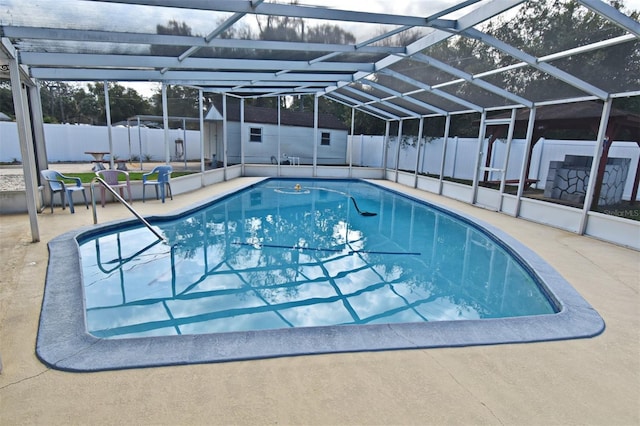 view of pool with a shed, a lanai, and a patio area