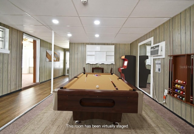 recreation room featuring a drop ceiling, a wall mounted air conditioner, billiards, and wood walls