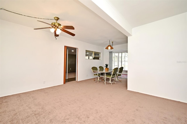 interior space featuring ceiling fan and carpet