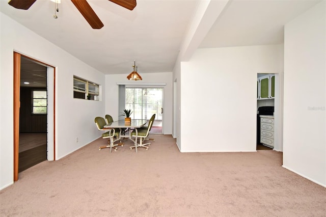 carpeted dining area featuring ceiling fan