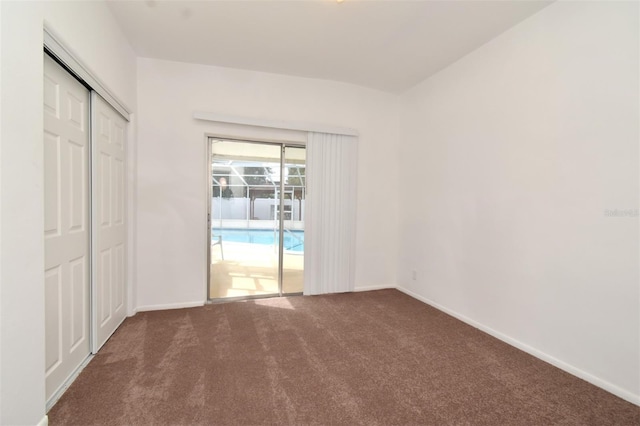 unfurnished room with dark carpet