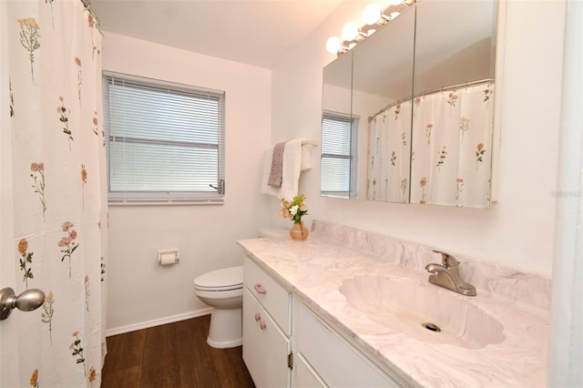 bathroom featuring vanity, toilet, and hardwood / wood-style floors