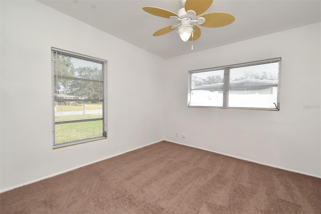 carpeted spare room with ceiling fan