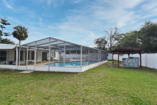 view of swimming pool featuring a gazebo, a lawn, and glass enclosure