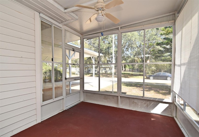 unfurnished sunroom featuring ceiling fan and a healthy amount of sunlight