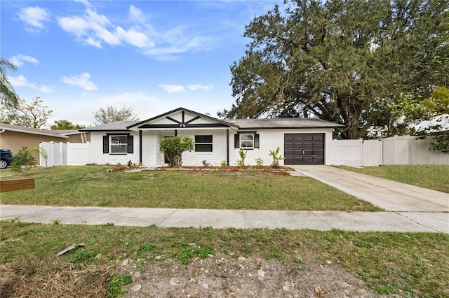 view of front facade with driveway, a garage, fence, and a front lawn