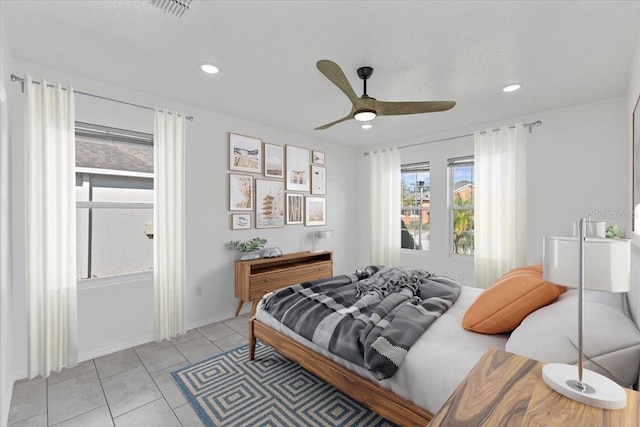 tiled bedroom featuring ceiling fan