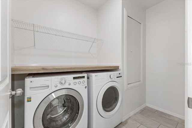 washroom with washing machine and clothes dryer