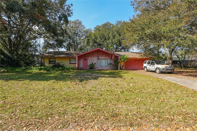 ranch-style home with a garage and a front lawn