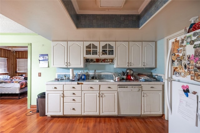 kitchen featuring white cabinetry, white appliances, and crown molding