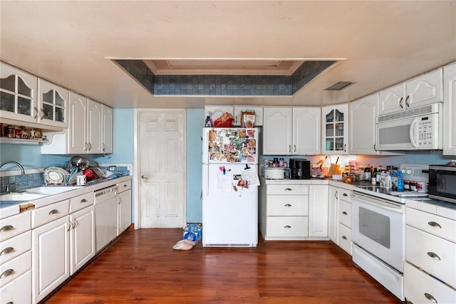 kitchen with white cabinetry, white appliances, and a tray ceiling