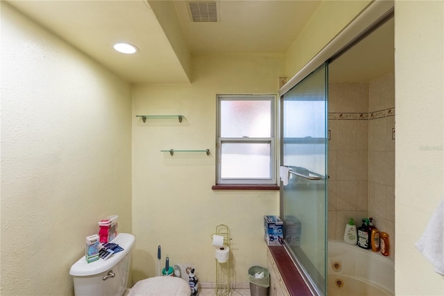 bathroom with enclosed tub / shower combo and toilet