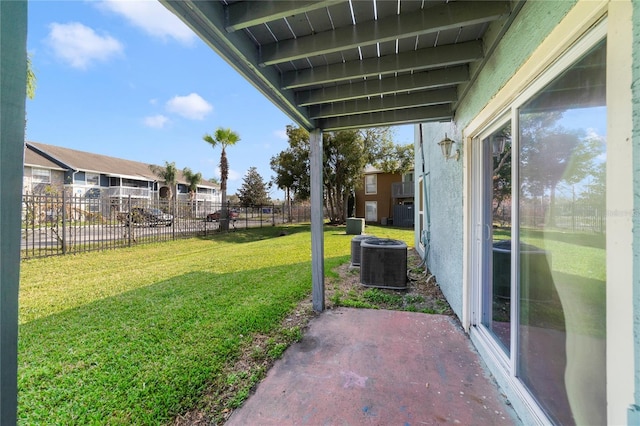 view of yard with central AC unit and a patio area