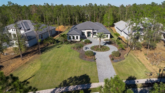 birds eye view of property featuring a wooded view