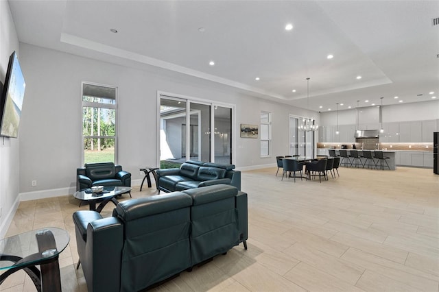 living room featuring visible vents, recessed lighting, baseboards, and a tray ceiling