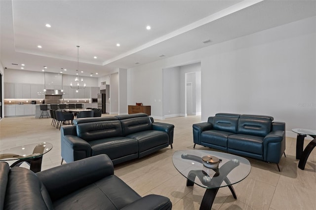 living room with recessed lighting, baseboards, a raised ceiling, and visible vents