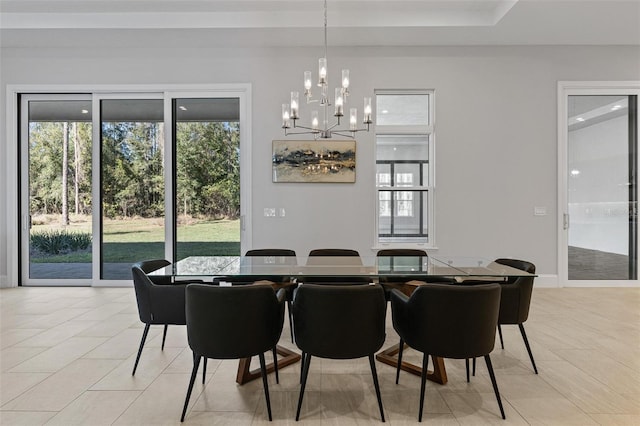 dining room with light tile patterned floors and a notable chandelier