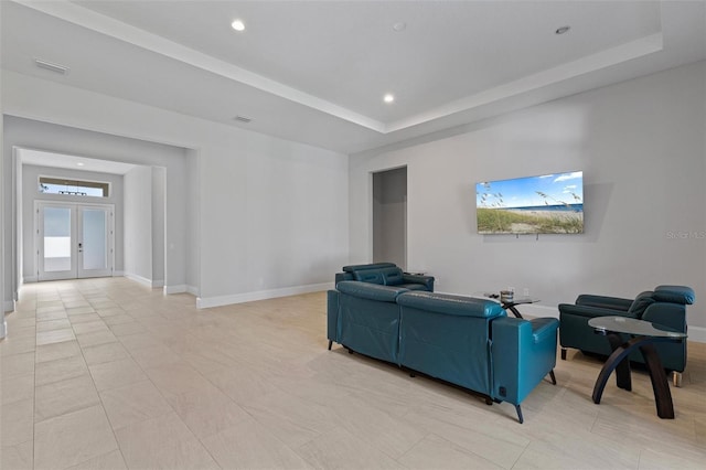 living room with visible vents, a tray ceiling, recessed lighting, french doors, and baseboards