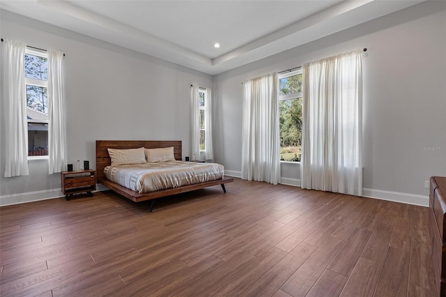 bedroom with recessed lighting, baseboards, and wood finished floors