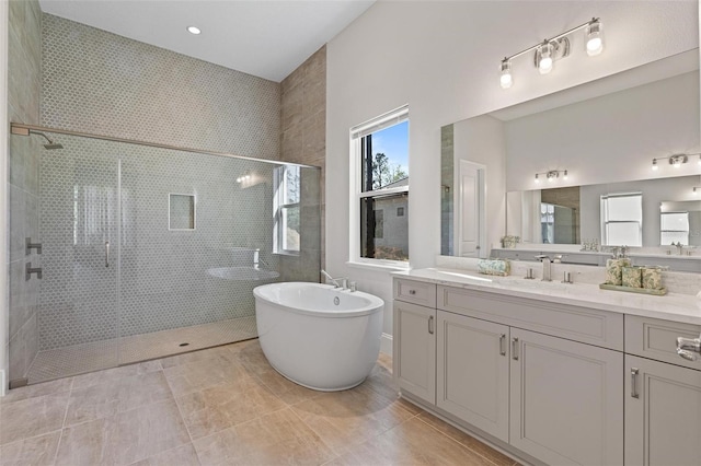 full bath with vanity, a soaking tub, and a shower stall