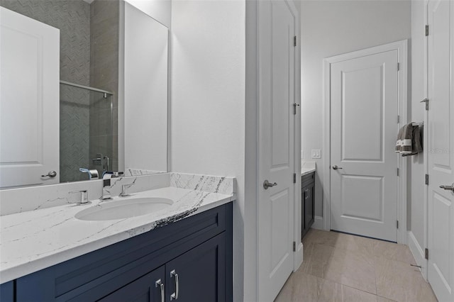 bathroom featuring vanity, a shower stall, and tile patterned flooring