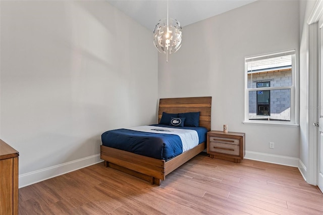 bedroom featuring baseboards and wood finished floors