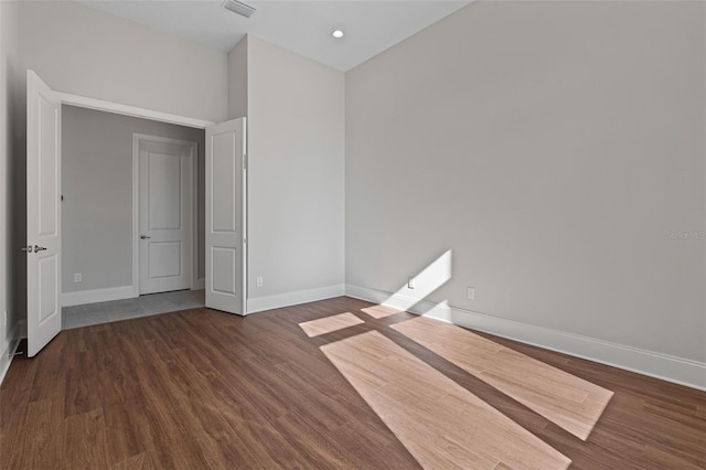 interior space with visible vents, baseboards, and wood finished floors