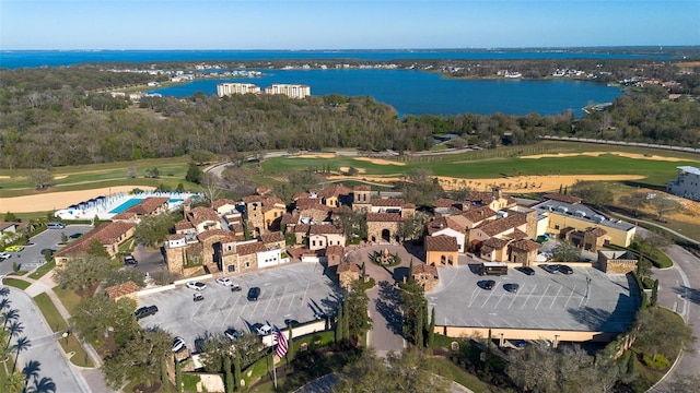 birds eye view of property with a water view and golf course view