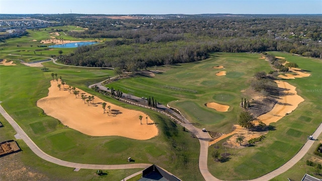 birds eye view of property featuring golf course view, a forest view, and a water view