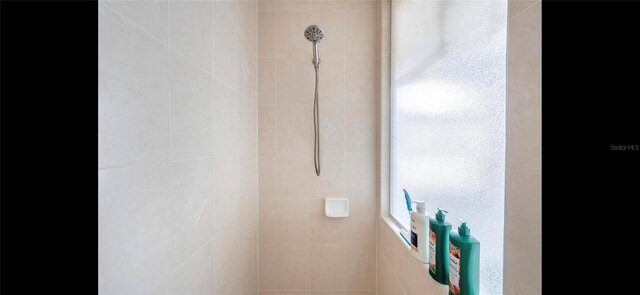 bathroom with tiled shower