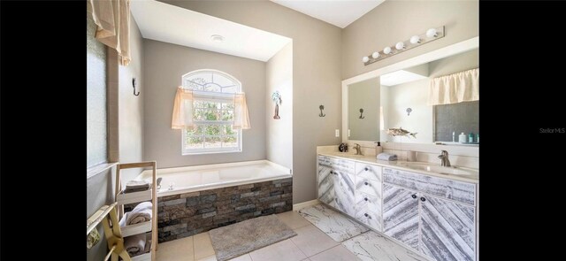 bathroom with vanity and tiled bath