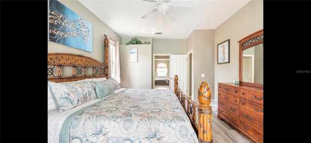 bedroom with light hardwood / wood-style floors and ceiling fan