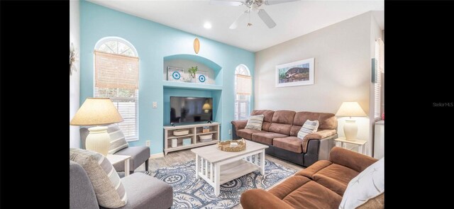 living room with ceiling fan and light wood-type flooring