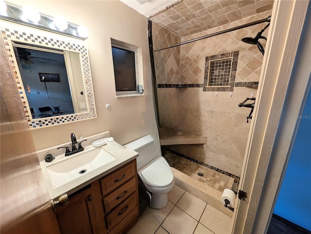 bathroom with toilet, a stall shower, tile patterned flooring, and vanity