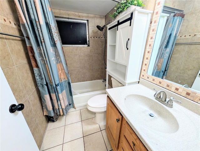 bathroom with tile patterned flooring, toilet, vanity, tile walls, and shower / bath combo