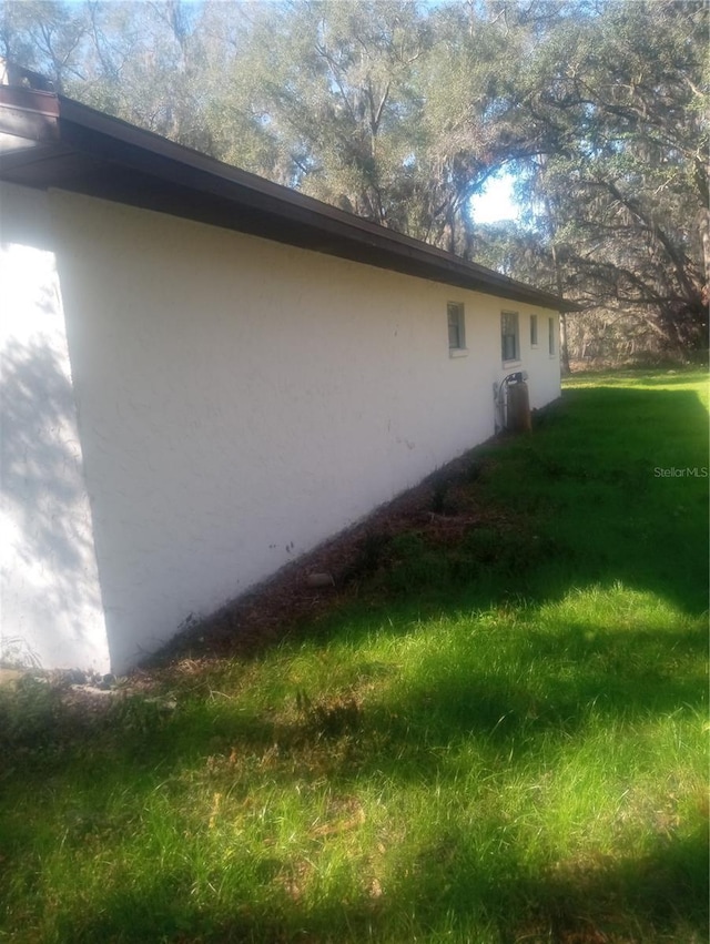 view of home's exterior with a lawn