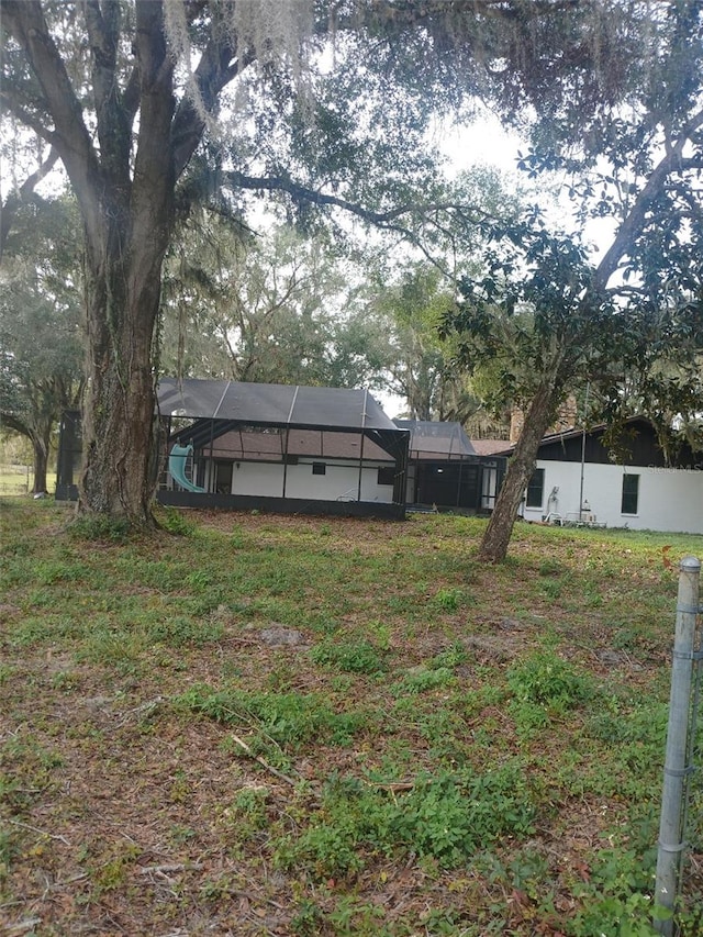 view of yard featuring glass enclosure