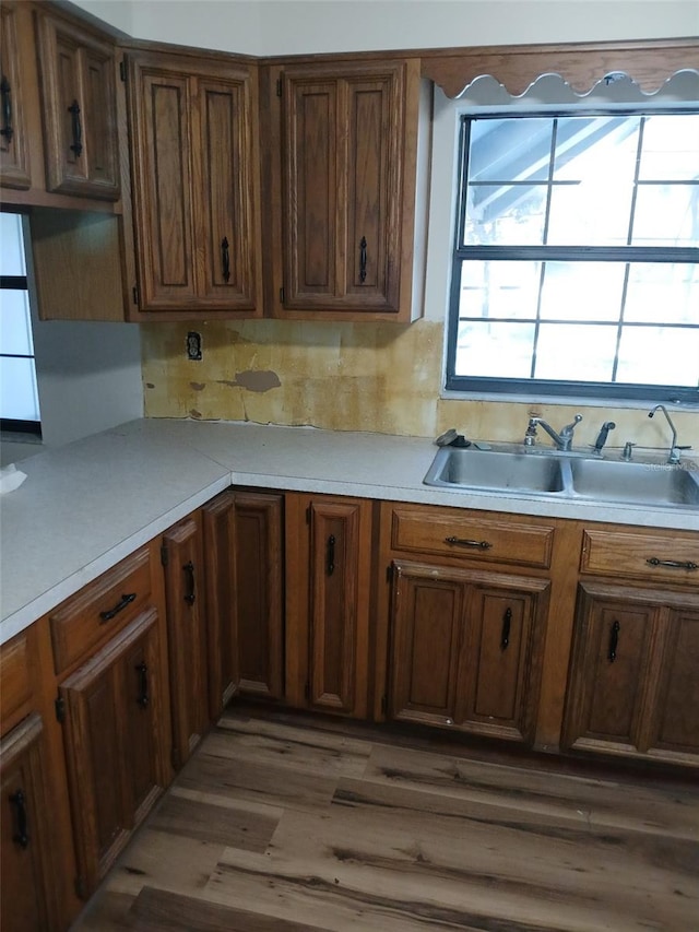 kitchen featuring dark wood-type flooring, sink, and tasteful backsplash