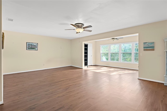 unfurnished room with ceiling fan and dark hardwood / wood-style flooring