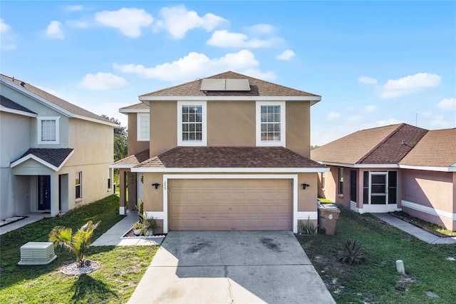 front of property with a front yard and a garage