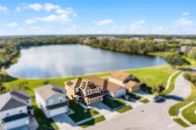 birds eye view of property with a water view