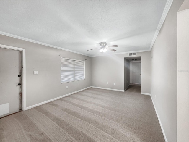 carpeted empty room with ceiling fan, ornamental molding, and a textured ceiling